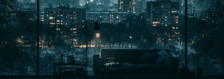 An empty room overlooking a snow-covered city