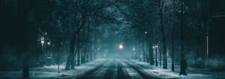 Empty snow-covered street at night with a distant warm light, symbolizing forgotten memories and nostalgic ambient music
